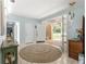 Bright foyer featuring a tile floor, sky-blue walls, unique light fixtures, and decorative furniture at 3000 Pine Grove Ln, Lady Lake, FL 32159