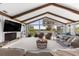 Open living room boasts a fireplace, exposed beams, and serene water views through expansive windows at 3000 Pine Grove Ln, Lady Lake, FL 32159