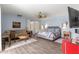 Comfortable primary bedroom featuring a ceiling fan and sitting area, great for relaxing and unwinding at 3000 Pine Grove Ln, Lady Lake, FL 32159