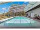 Enclosed in-ground pool featuring a screened cage, lounge chairs, and outdoor greenery at 3000 Pine Grove Ln, Lady Lake, FL 32159