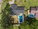Aerial view of a backyard with a rectangular pool, well-manicured lawn, and privacy fence at 327 Se 50Th Ave, Ocala, FL 34471