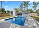 Backyard with a large swimming pool and surrounding lawn at 327 Se 50Th Ave, Ocala, FL 34471