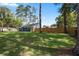 Spacious backyard featuring lush green grass, a tall privacy fence, and the exterior of a single-Gathering home at 327 Se 50Th Ave, Ocala, FL 34471