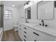 Modern bathroom featuring dual sinks, marble countertops, and sleek black fixtures at 327 Se 50Th Ave, Ocala, FL 34471