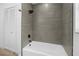 Bathroom with gray subway tile and white shower and tub combination at 327 Se 50Th Ave, Ocala, FL 34471