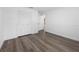 Bedroom with closet and wood-look flooring and view to hallway at 327 Se 50Th Ave, Ocala, FL 34471