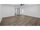 Spacious bedroom with ceiling fan, en-suite closet, and durable gray wood-look floors at 327 Se 50Th Ave, Ocala, FL 34471