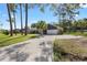 Wide driveway leading to a home with a two-car garage, stone accents, and a well-maintained lawn at 327 Se 50Th Ave, Ocala, FL 34471