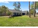 Charming single-story home showcasing stone accents, lush lawn, and mature trees in a desirable neighborhood at 327 Se 50Th Ave, Ocala, FL 34471