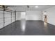 Spacious garage with epoxy flooring, offering ample parking and storage at 327 Se 50Th Ave, Ocala, FL 34471