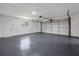 Spacious garage with epoxy flooring, side door, and window at 327 Se 50Th Ave, Ocala, FL 34471