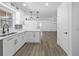 Modern kitchen with white cabinetry, stylish countertops, and hardwood floors throughout at 327 Se 50Th Ave, Ocala, FL 34471