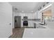 Updated kitchen with stainless steel appliances and white cabinetry at 327 Se 50Th Ave, Ocala, FL 34471