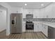 Bright kitchen featuring stainless steel appliances, ample white cabinetry, and sleek countertops at 327 Se 50Th Ave, Ocala, FL 34471