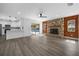 Open-concept living area with a stone fireplace and view of the pool at 327 Se 50Th Ave, Ocala, FL 34471