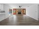 Open-concept living space with wood-look floors and a unique stone fireplace at 327 Se 50Th Ave, Ocala, FL 34471
