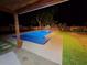 Night shot of the backyard pool with a covered porch area at 327 Se 50Th Ave, Ocala, FL 34471