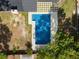 Aerial view of a backyard pool and patio area surrounded by trees at 327 Se 50Th Ave, Ocala, FL 34471