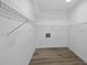 Walk-in closet with ample shelving, overhead lighting, and modern wood-look flooring at 327 Se 50Th Ave, Ocala, FL 34471