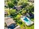 Aerial view of a community pool surrounded by lush lawns, and the tops of nearby homes at 3833 Ne 17Th Street Cir, Ocala, FL 34470