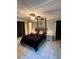 Well-lit bedroom with queen-sized bed, side tables, tiled floor and closet at 3833 Ne 17Th Street Cir, Ocala, FL 34470