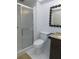 Bathroom with stand up shower, toilet, vanity, and decorative mirror at 3856 Ne 17Th Street Cir, Ocala, FL 34470