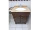 Bathroom features a vanity with a light tan countertop and dark wood cabinets at 3856 Ne 17Th Street Cir, Ocala, FL 34470