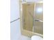 Bathroom featuring a shower/tub with sliding doors, complemented by a chrome shower head and handle at 3856 Ne 17Th Street Cir, Ocala, FL 34470