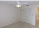 Bedroom with carpet, ceiling fan, and a closet with folding louvered doors at 3856 Ne 17Th Street Cir, Ocala, FL 34470