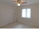 Bedroom with a carpet, window, and ceiling fan with light fixture at 3856 Ne 17Th Street Cir, Ocala, FL 34470