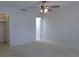 A bright bedroom with a ceiling fan and a walk-in closet at 3856 Ne 17Th Street Cir, Ocala, FL 34470