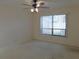 Bedroom with a ceiling fan and window at 3856 Ne 17Th Street Cir, Ocala, FL 34470