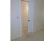 Bedroom showcasing an open doorway with carpeted floors and a closet with louvered doors at 3856 Ne 17Th Street Cir, Ocala, FL 34470
