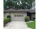Charming home with a two-car garage, lush landscaping, and a well-manicured lawn at 3856 Ne 17Th Street Cir, Ocala, FL 34470