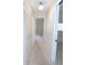 Hallway with white walls and doors leading to other rooms with carpeted floor at 3856 Ne 17Th Street Cir, Ocala, FL 34470