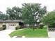 Charming home exterior with well-kept lawn, inviting entrance, and neatly trimmed shrubs at 3856 Ne 17Th Street Cir, Ocala, FL 34470