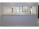 Kitchen featuring a serving counter and view into the cooking area with window above the sink at 3856 Ne 17Th Street Cir, Ocala, FL 34470