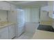 Clean kitchen with white cabinets, appliances, and window at 3856 Ne 17Th Street Cir, Ocala, FL 34470