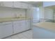 Bright kitchen features white cabinets, appliances, and tile flooring at 3856 Ne 17Th Street Cir, Ocala, FL 34470