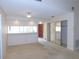 Living room with a bar top area to the kitchen with closet and access to the entry at 3856 Ne 17Th Street Cir, Ocala, FL 34470