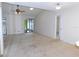 Bright living room with vaulted ceilings, ceiling fan, and access to an enclosed lanai at 3856 Ne 17Th Street Cir, Ocala, FL 34470