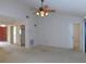 Large living room featuring neutral tones with a ceiling fan and closet space at 3856 Ne 17Th Street Cir, Ocala, FL 34470