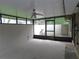 Enclosed patio with screened windows and a ceiling fan, providing an airy space for outdoor enjoyment at 3856 Ne 17Th Street Cir, Ocala, FL 34470