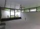 Enclosed patio with screened windows and a ceiling fan, offering an outdoor view and additional living space at 3856 Ne 17Th Street Cir, Ocala, FL 34470