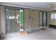 Enclosed patio showcasing sliding glass doors with a dog door insert, offering access to the indoors at 3856 Ne 17Th Street Cir, Ocala, FL 34470