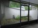 Enclosed patio featuring screened windows with an outdoor view, seamlessly blending indoor and outdoor living at 3856 Ne 17Th Street Cir, Ocala, FL 34470