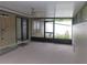 Enclosed patio with ceiling fan offers a tranquil outdoor space, perfect for entertaining or relaxing at 3856 Ne 17Th Street Cir, Ocala, FL 34470