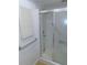 Bathroom shower with glass sliding doors, a showerhead, and grab bars for support at 3856 Ne 17Th Street Cir, Ocala, FL 34470
