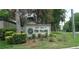 Entrance sign for Patio Homes of the Village is surrounded by manicured landscaping at 3856 Ne 17Th Street Cir, Ocala, FL 34470