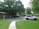 Neighborhood street view highlighting mature trees and a parked car, showcasing a tranquil setting at 3856 Ne 17Th Street Cir, Ocala, FL 34470
